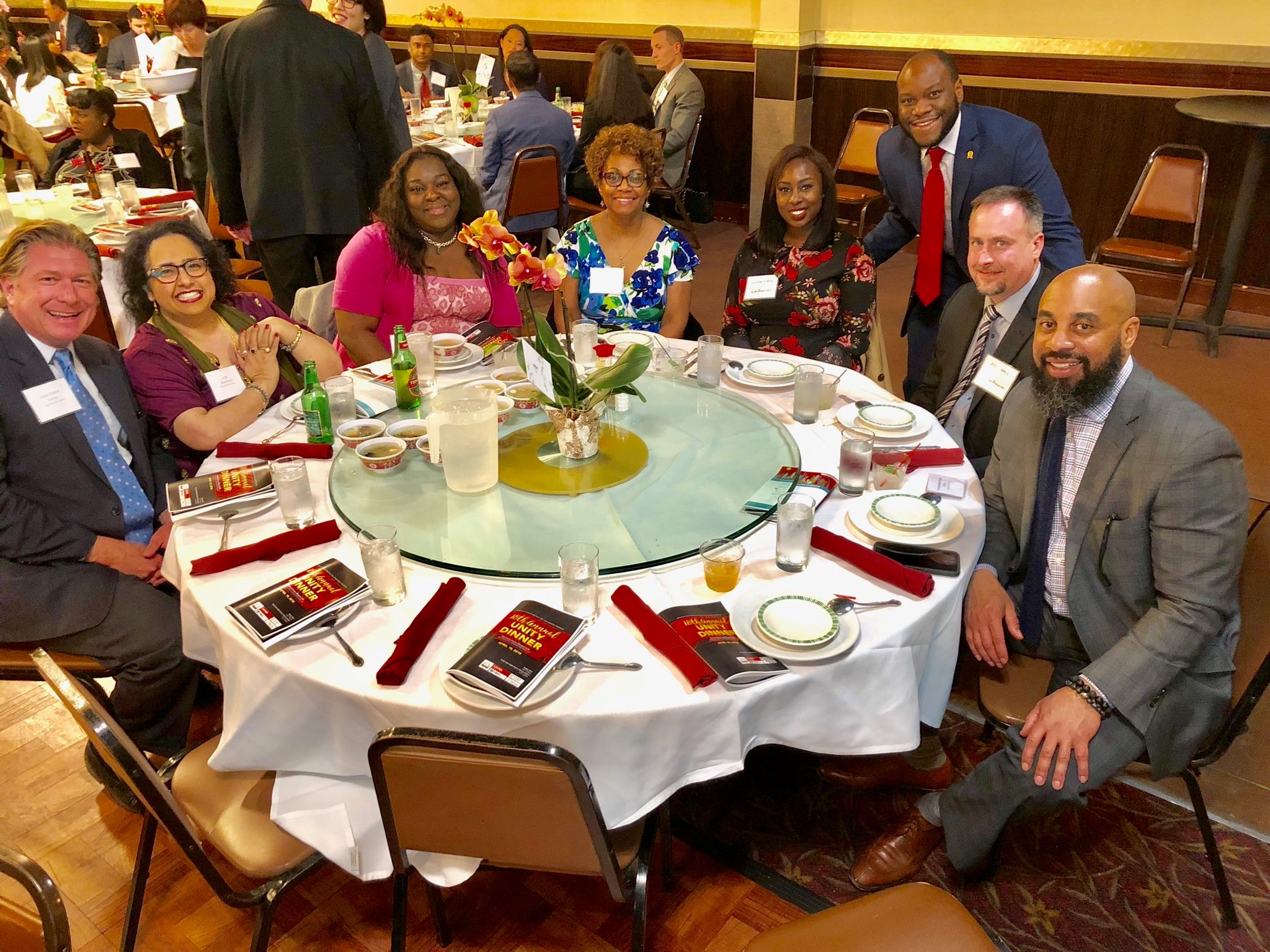 Group of men and women, including HeplerBroom attorney Eric Hall, sitting around a round table at the Annual Unity Dinner