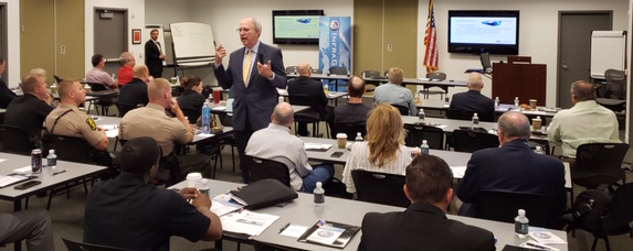 HeplerBroom attorney Glenn Davis speaking to a classroom of men and women, some of whom are in law enforcement uniforms