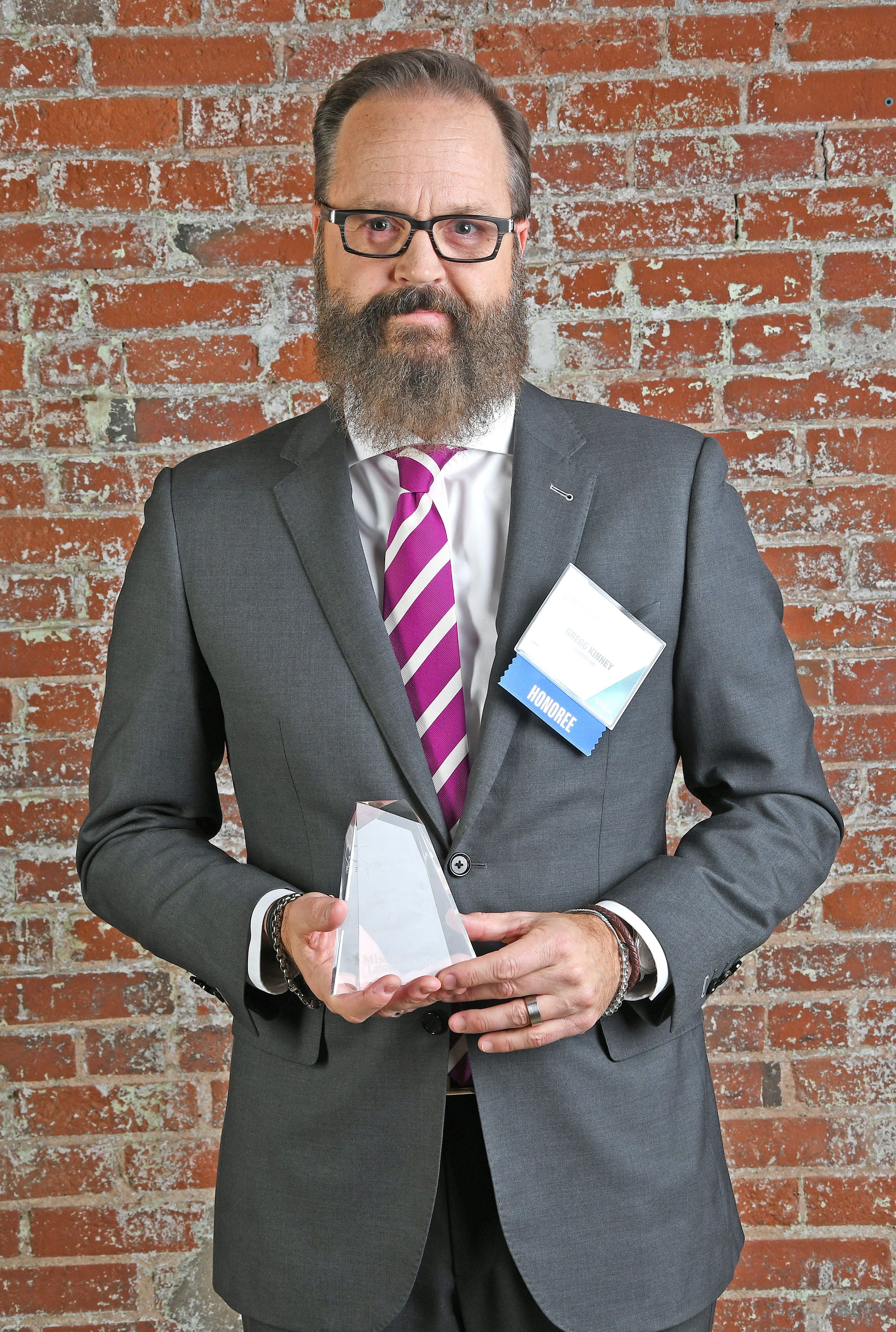 HeplerBroom Attorney Gregg Kinney holding HeplerBroom's 2019 Legal Innovation Award given by Missouri Lawyers Media