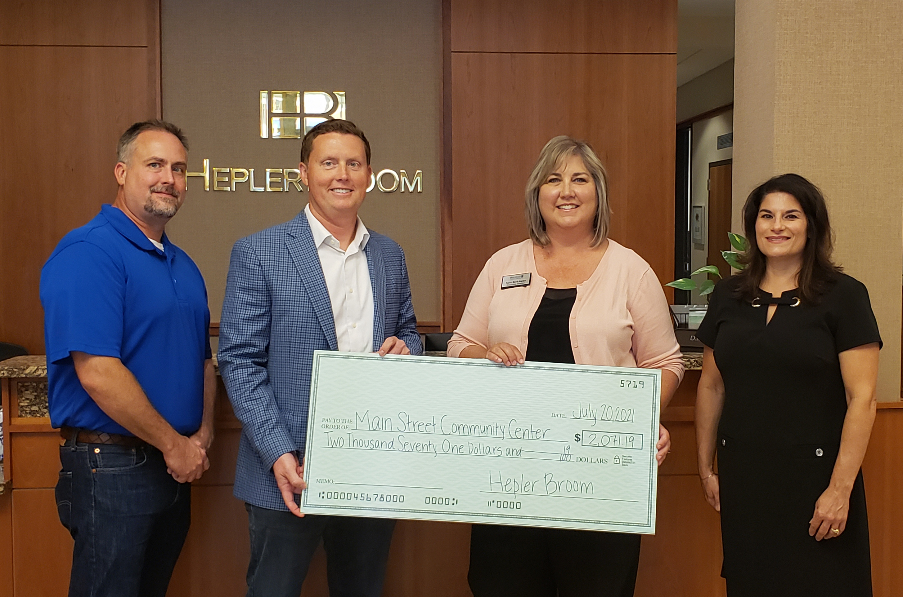 HB attorneys Eric Hall and Matt Champlin present check to Community Center's Executive Director Sara Berkbigler and President of Board Gina McNabnay