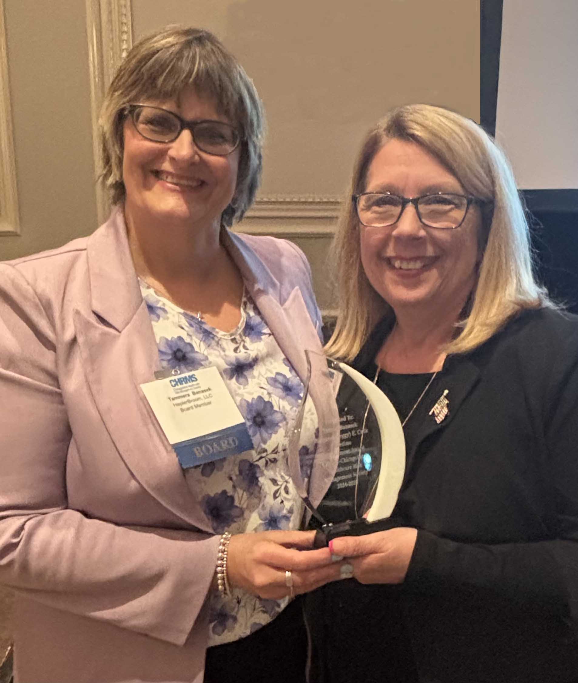 Tammy Banasek (left) receiving Peggy Cwik Award from Kim Passananti, president of CHRMS