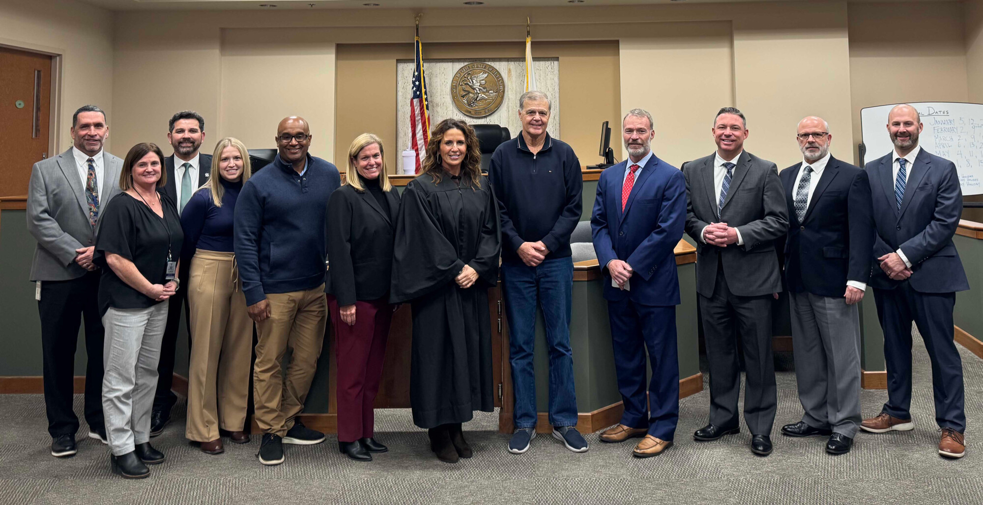 men and women standing in front of courtroom